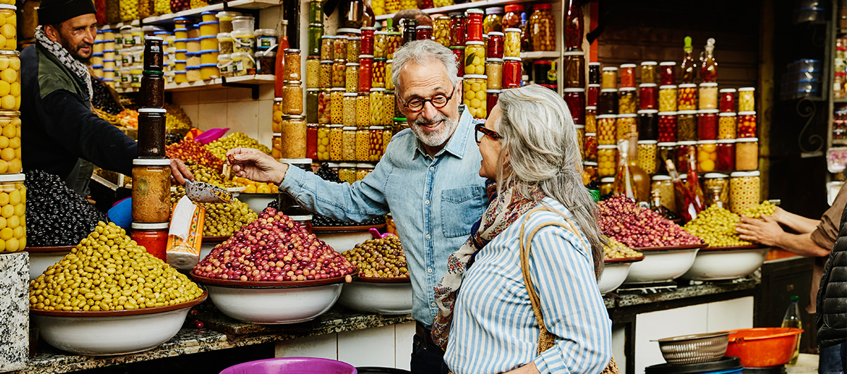 Couple trying olives at a market