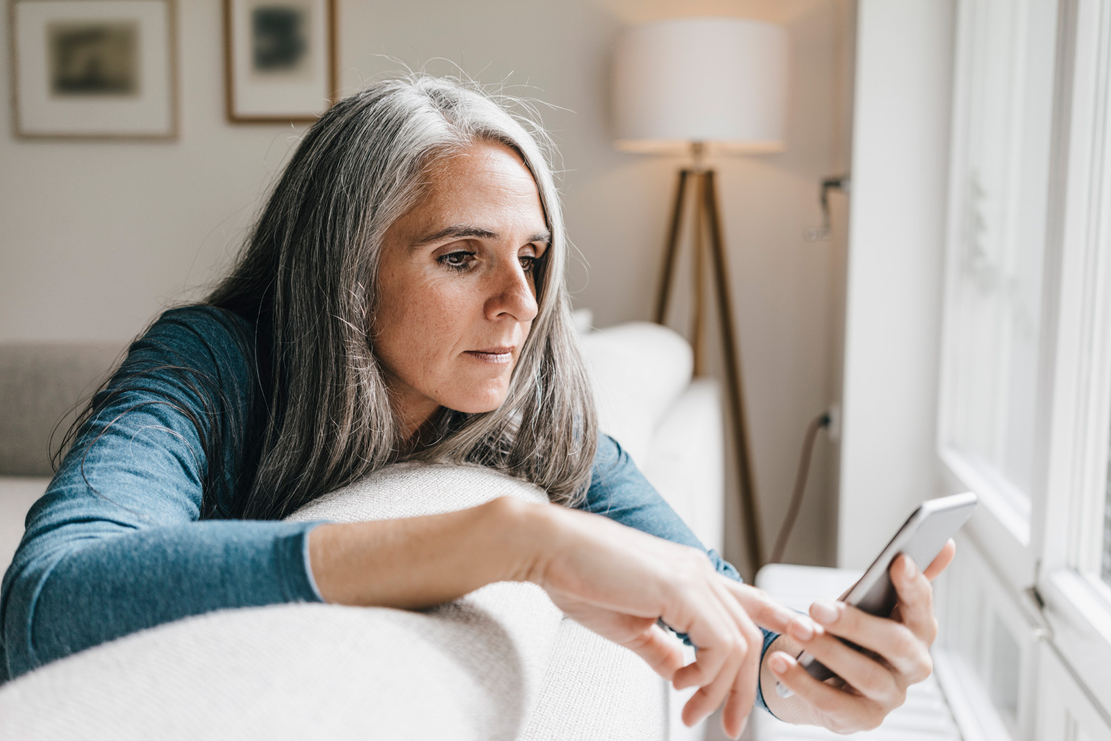 A woman looking at her phone with concern