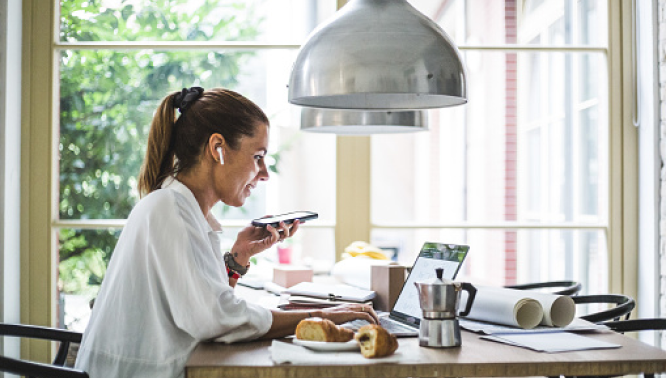 Woman on phone call at dining table